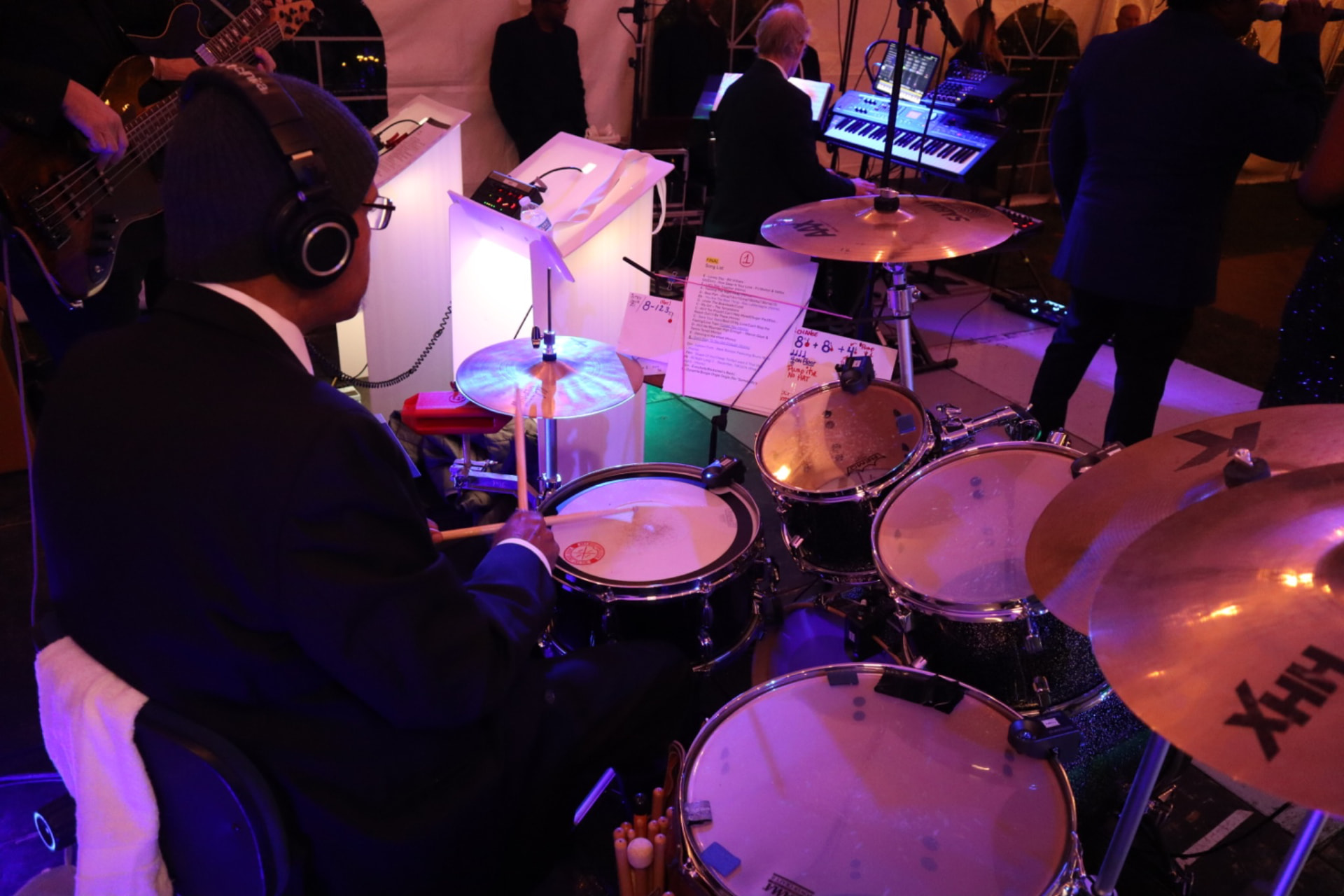 Gordon Dukes Music Company drummer reading a marked set list at the kit during sound check