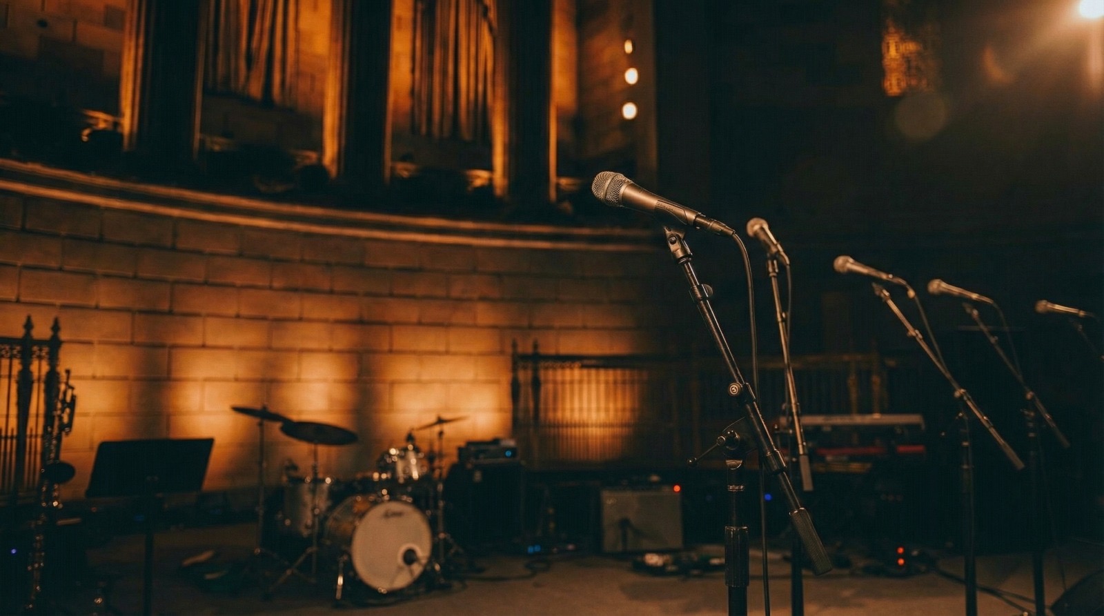 Gordon Dukes Music Company — microphones and instruments set on a candlelit stage before the performance, New York