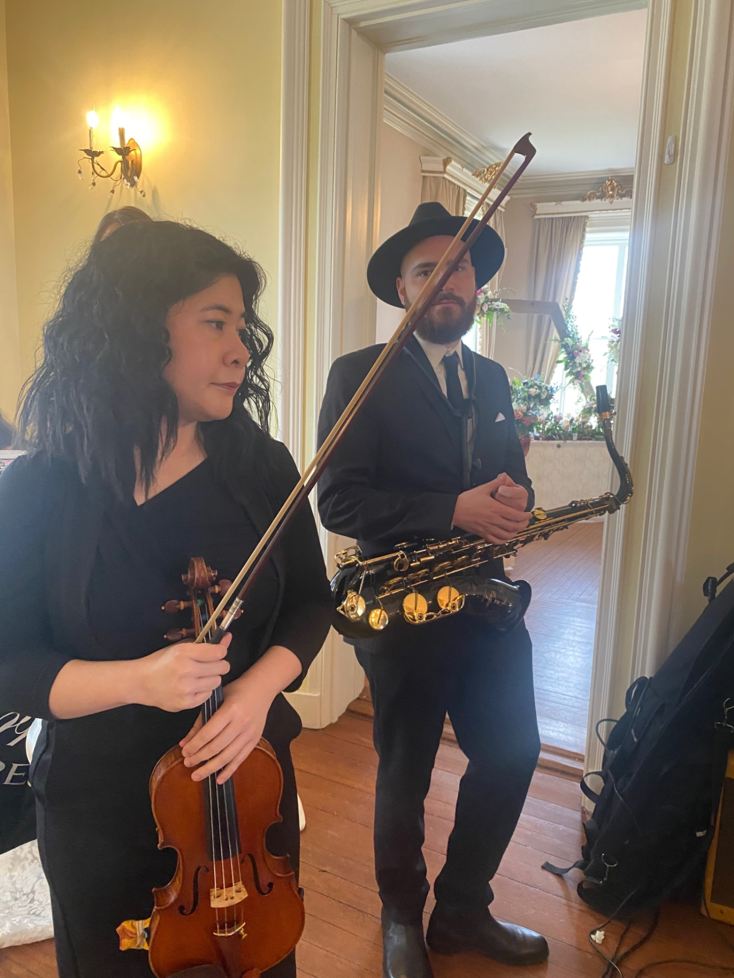 A Gordon Dukes Music Company violinist and saxophonist waiting in a hallway before the ceremony