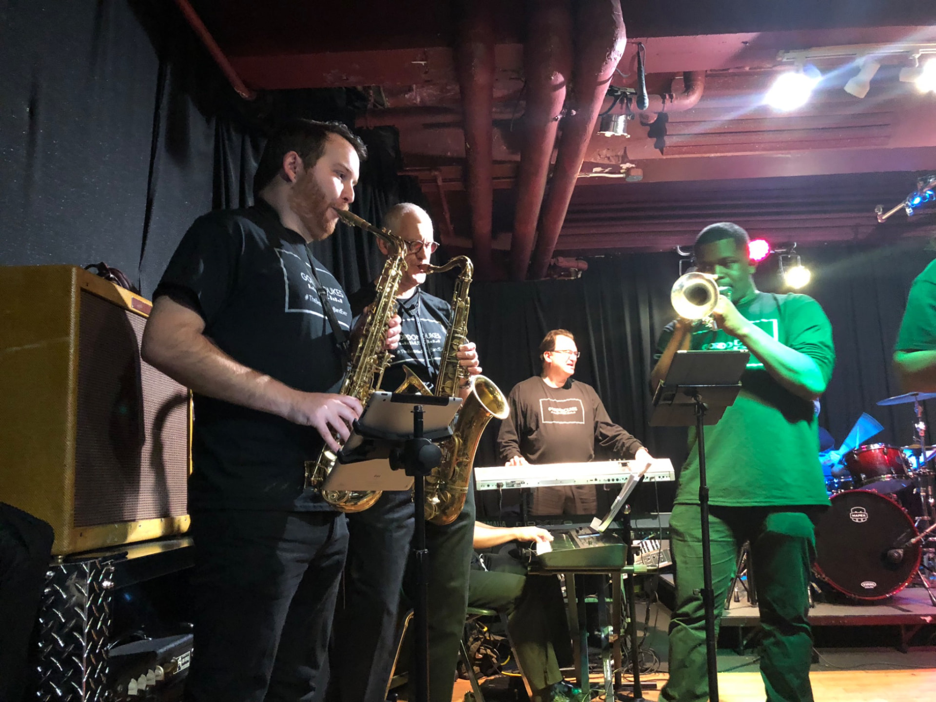 Gordon Dukes Music Company horn section and keyboard player on a club stage