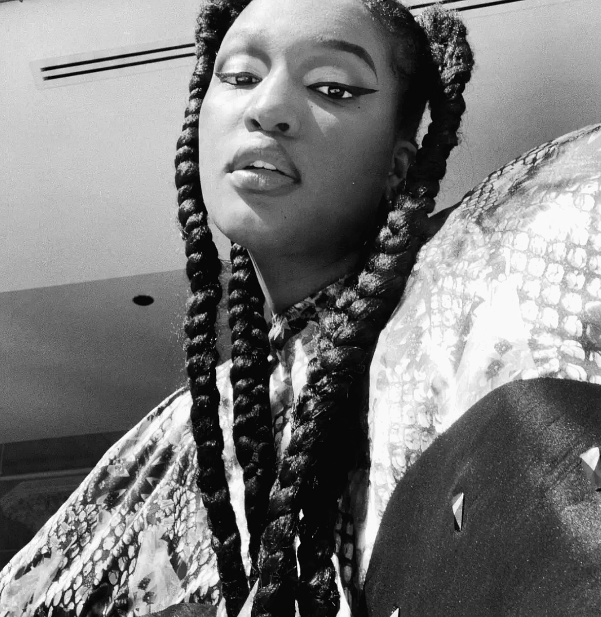 Denver Dukes of Gordon Dukes Music Company, black and white portrait with long braids in natural light