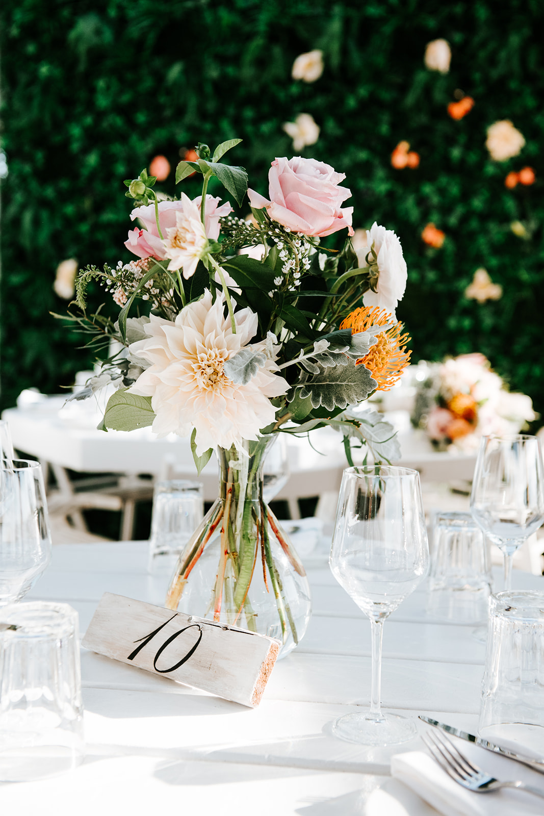 A single floral centerpiece on the reception table