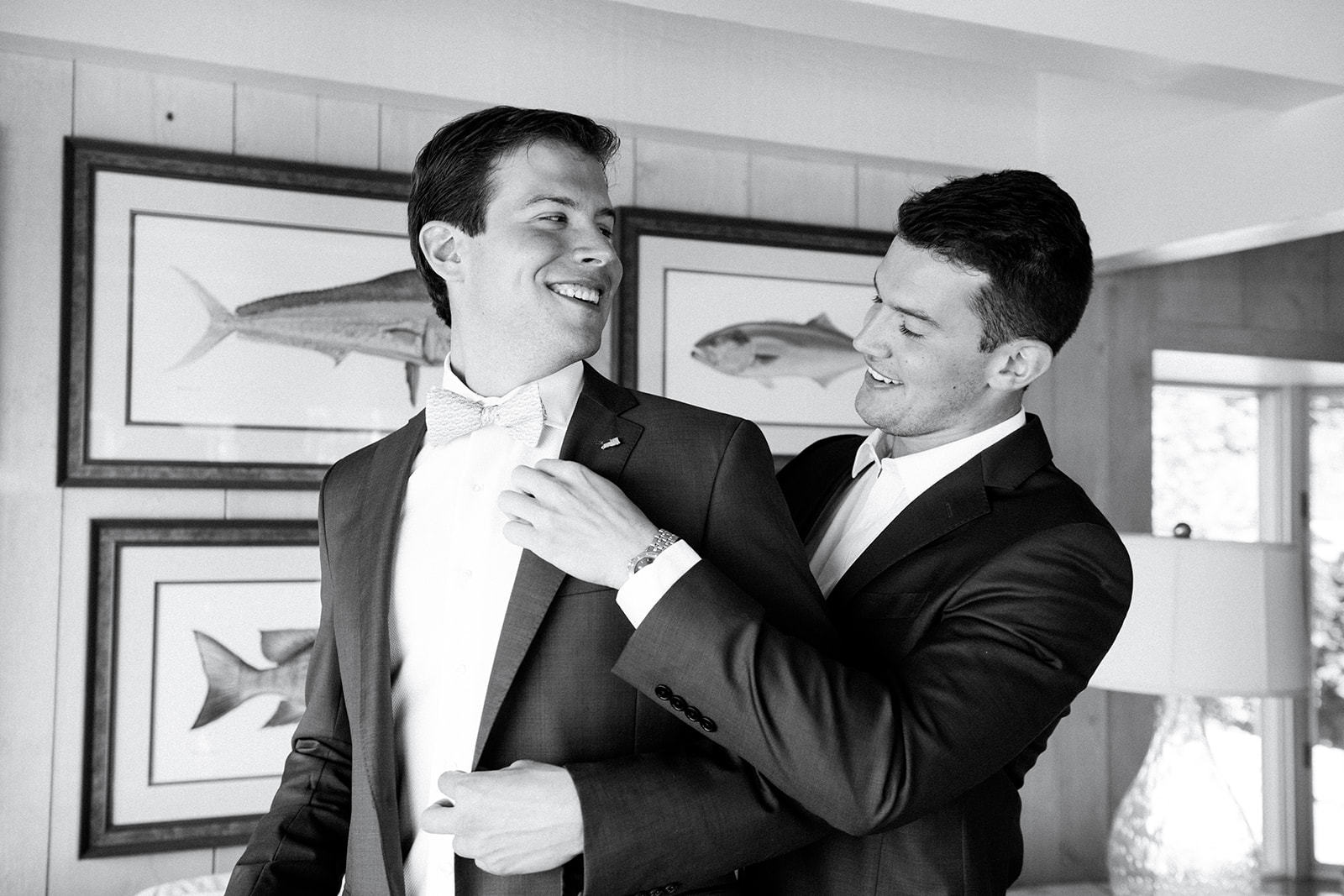 Groom having his bow tie straightened before the reception