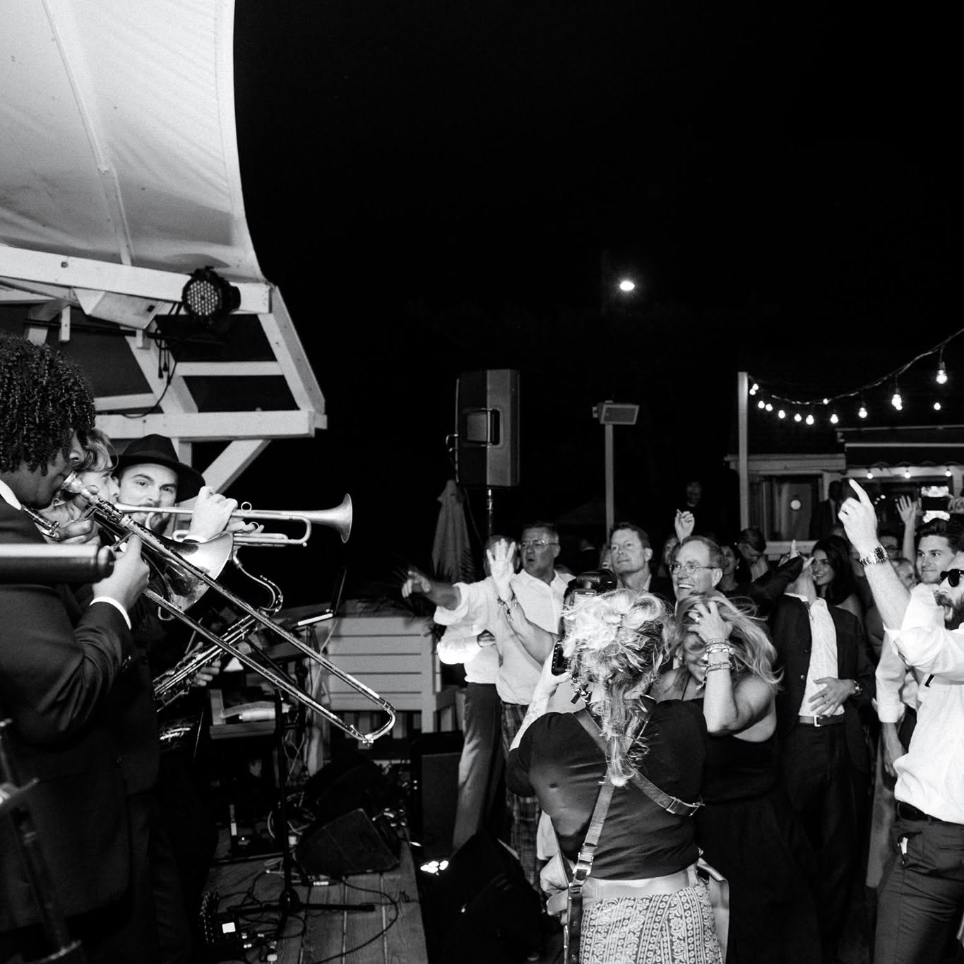 Guests raising horns and voices on the dance floor