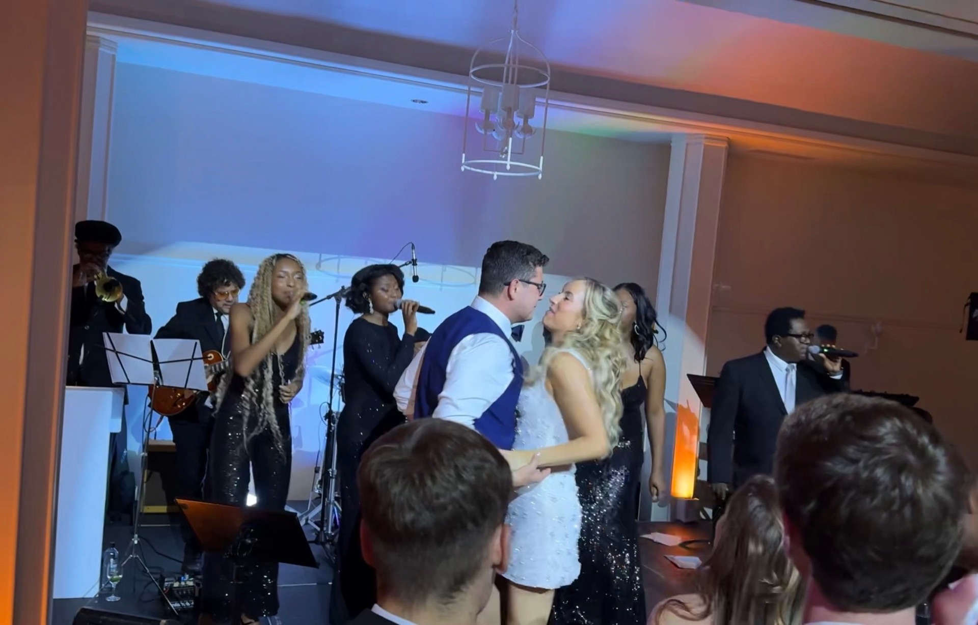 Bride and groom dancing surrounded by the Gordon Dukes vocalists