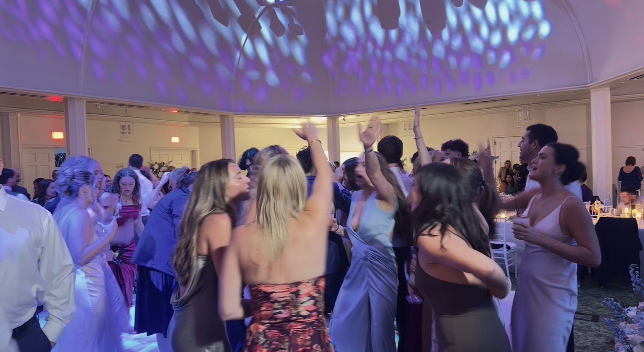 Guests with their hands in the air on a packed dance floor